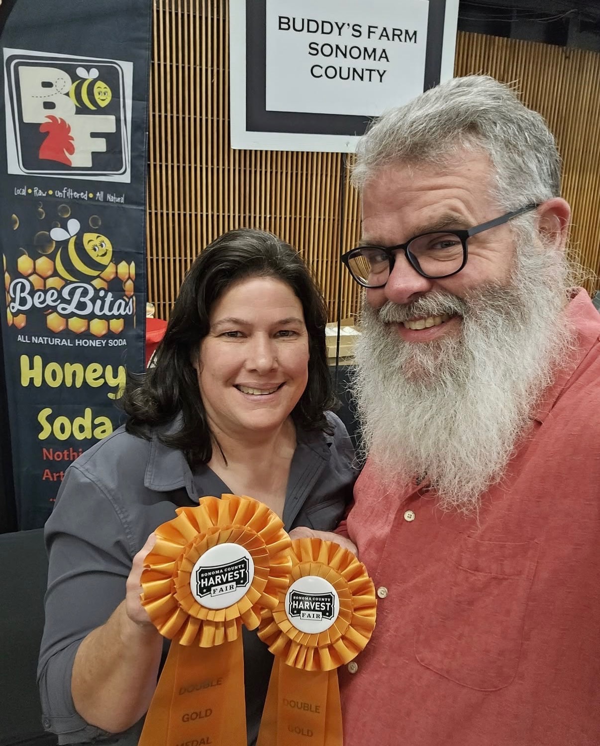 BeeBitas founders holding their Double Gold award ribbons